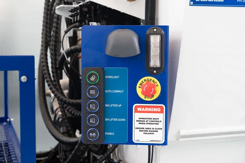 Operator control panel with labelled switches and an emergency stop.