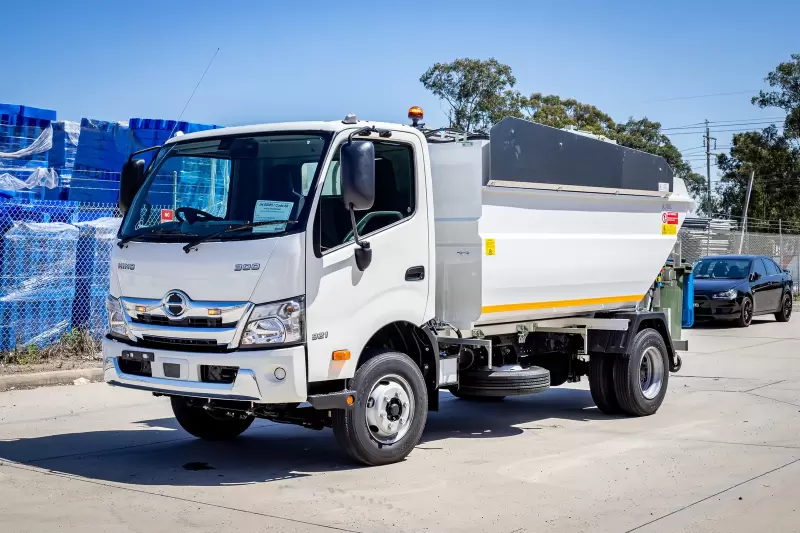 Russ Orbit compact rear loader on a Hino 300 chassis, front three-quarter view
